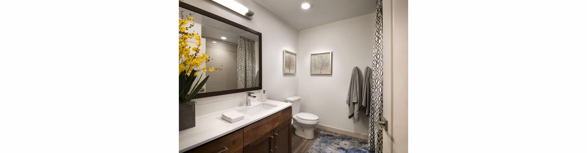 Modern bathroom with sleek fixtures and ample lighting at Nexa Apartments