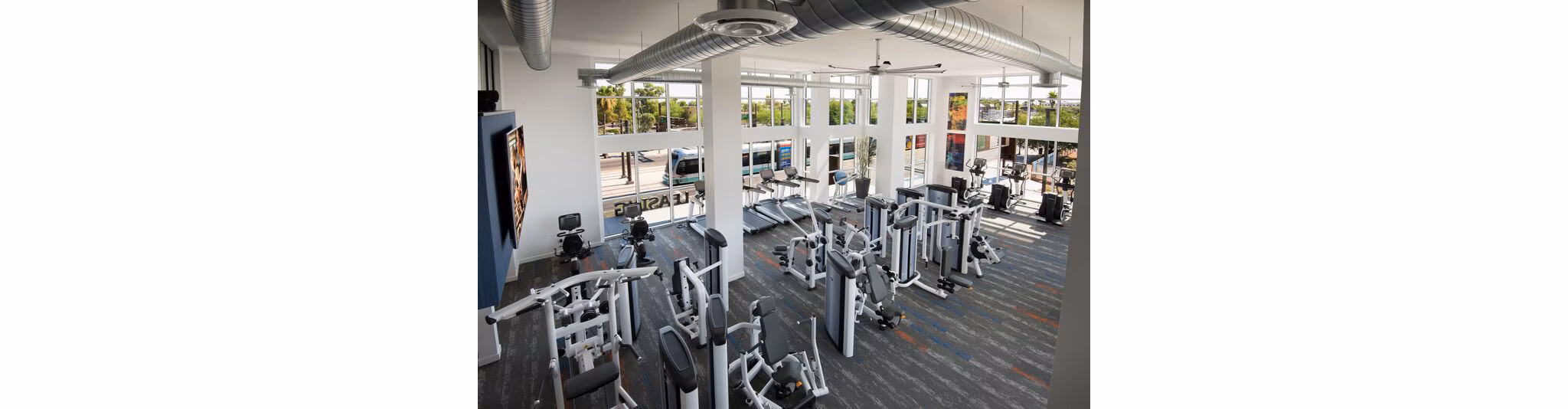 State-of-the-art fitness center at Nexa Apartments with cardio machines and free weights