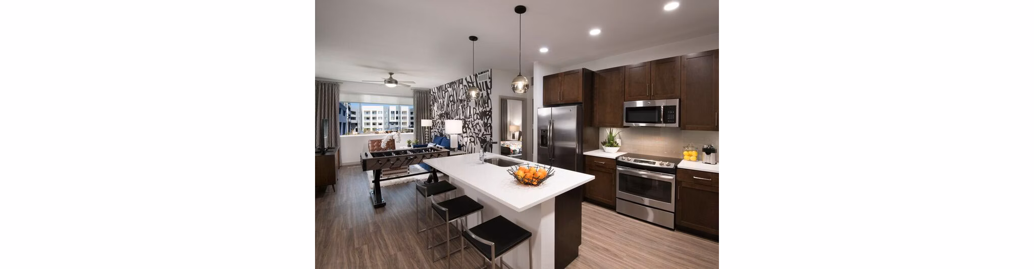 Modern kitchen featuring granite countertops and stainless steel appliances at Nexa Apartments