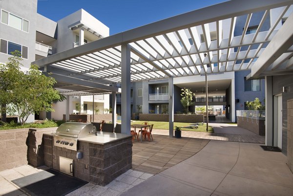 Grill area and patio at Nexa Apartments offering comfortable outdoor seating and cooking facilities