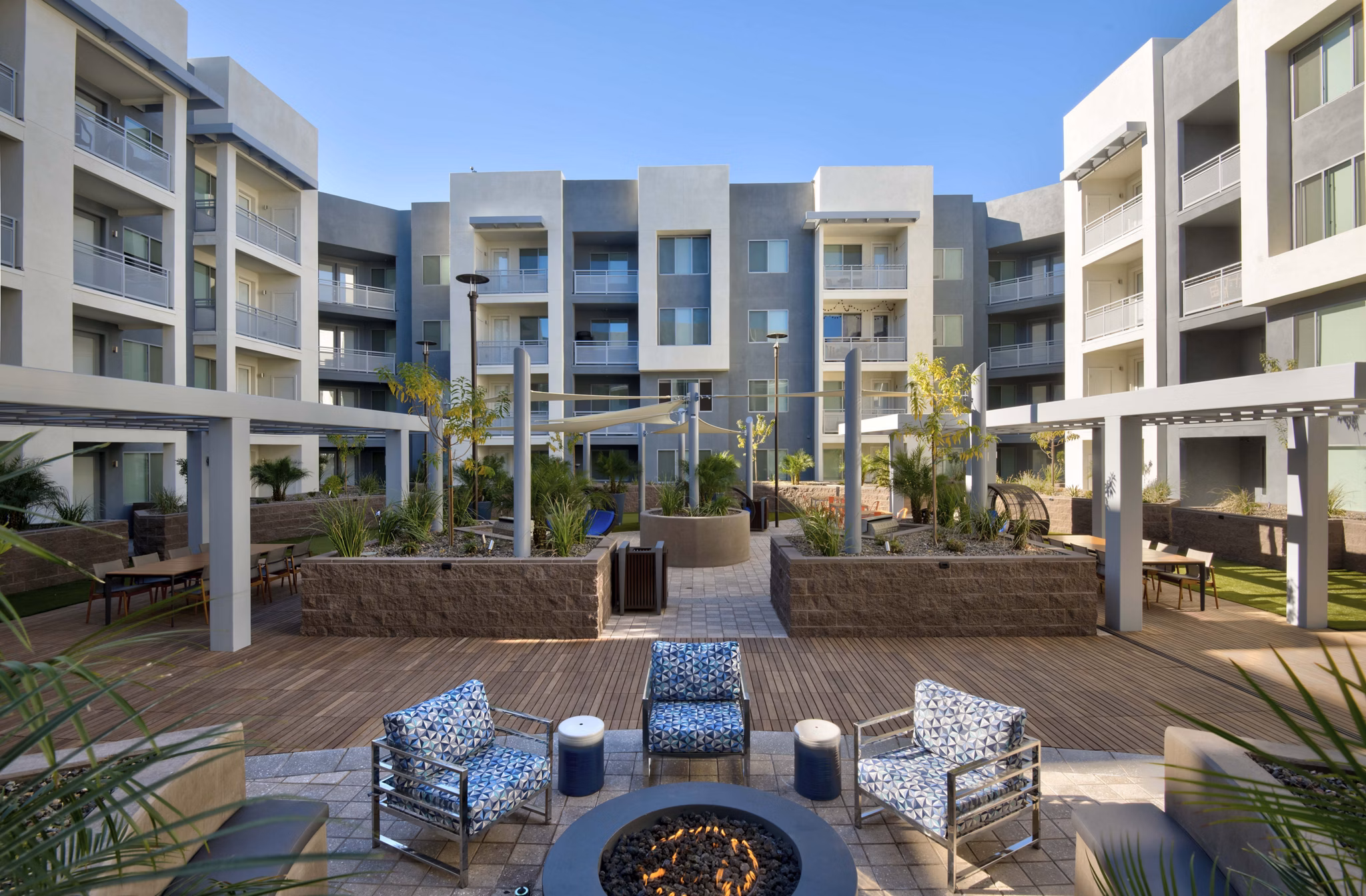 Modern outdoor patio with stylish seating at Nexa Apartments, a Greystar luxury property, offering a relaxing atmosphere for residents