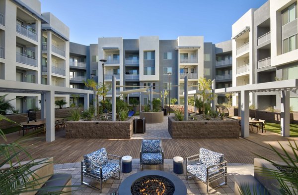 Modern outdoor patio with stylish seating at Nexa Apartments, a Greystar luxury property, offering a relaxing atmosphere for residents