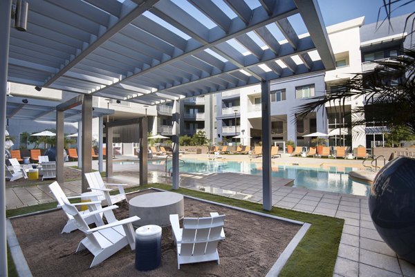 Pool patio area with modern seating and greenery at Nexa Apartments, offering luxury amenities in a vibrant community