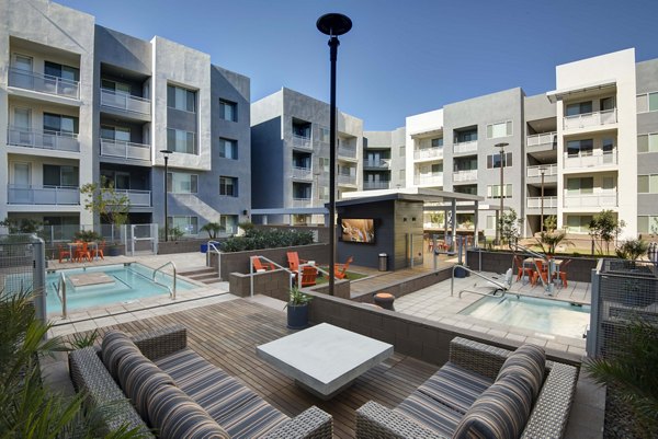 Relaxing outdoor hot tub on a stylish patio at Nexa Apartments