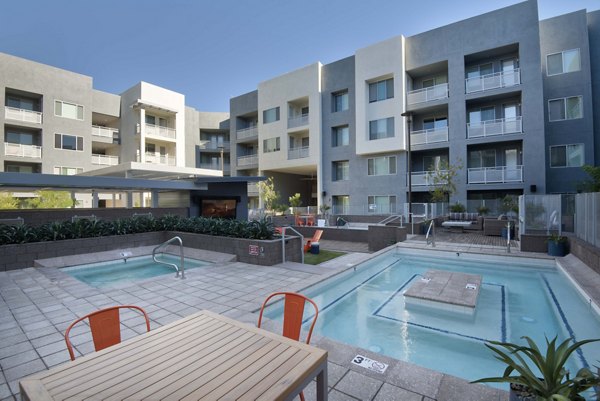 Hot tub oasis with wellness features in Nexa Apartments' pool area