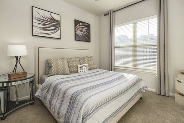 Cozy bedroom with modern decor at Ardmore & 28th Apartments, ideal for luxury living in a vibrant community