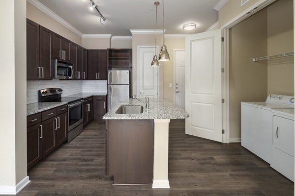 Modern kitchen with stainless steel appliances at Ardmore & 28th Apartments