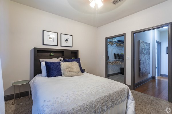 Cozy bedroom with modern furnishings at CB Lofts Apartments