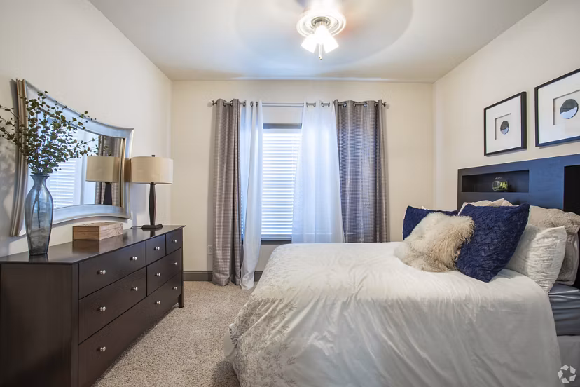 Cozy bedroom with stylish decor at CB Lofts Apartments featuring modern furnishings and ample natural light