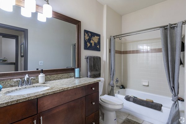 Bathroom featuring elegant marble countertops and modern fixtures at CB Lofts Apartments