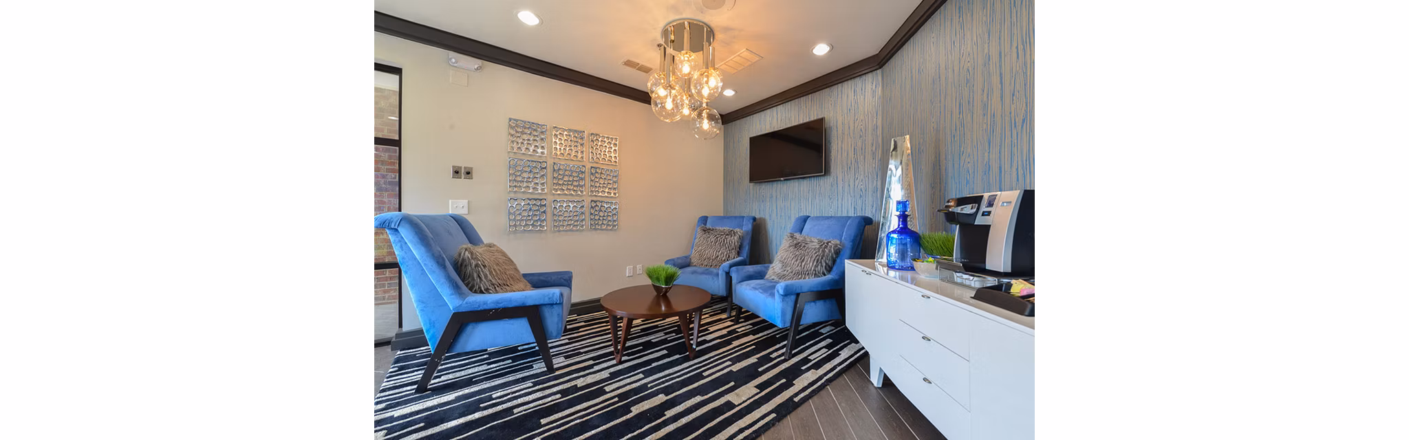 Clubhouse featuring modern design and spacious seating at CB Lofts Apartments