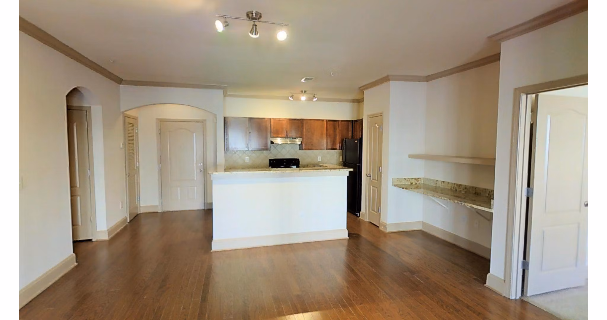 Contemporary kitchen with stainless steel appliances at CB Lofts Apartments, offering stylish urban living in a luxury setting