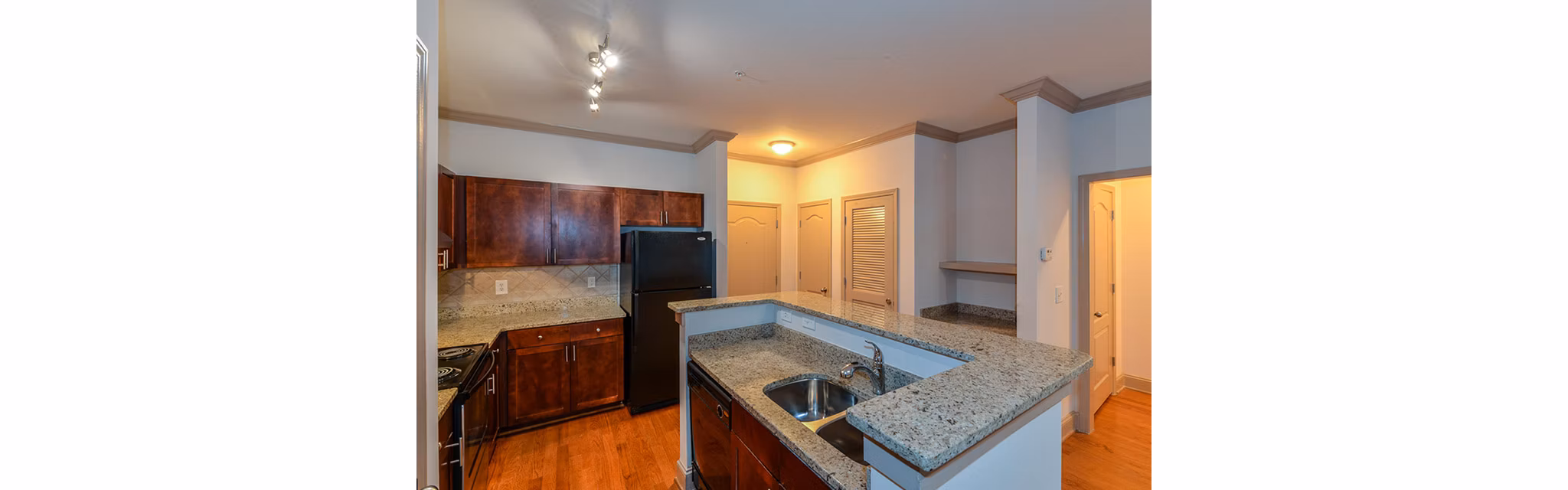 Kitchen featuring modern appliances and stylish cabinetry at CB Lofts Apartments