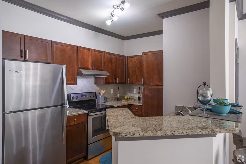 Modern kitchen featuring sleek countertops and stainless steel appliances in CB Lofts Apartments, ideal for luxury living