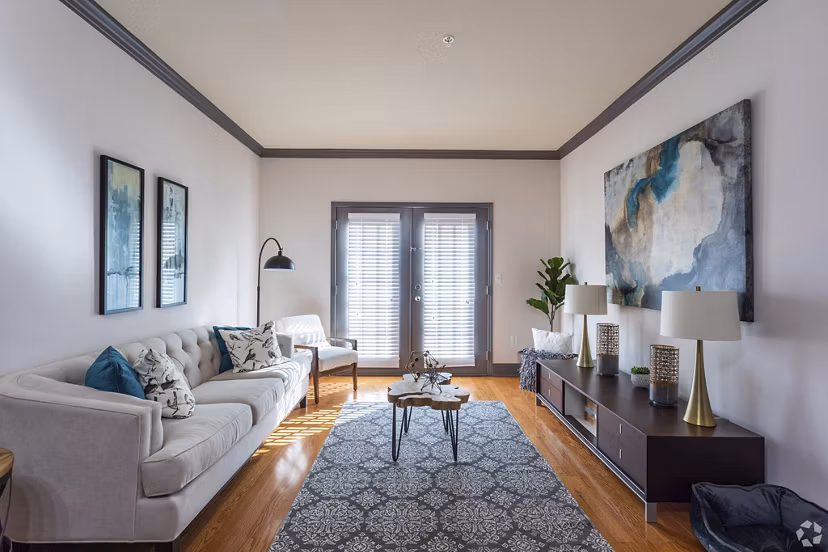 Living room with modern decor and large windows at CB Lofts Apartments