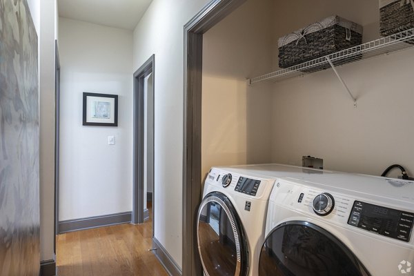 Laundry room with modern appliances at CB Lofts Apartments