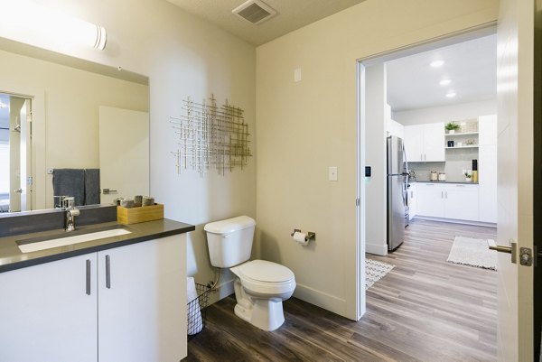 Luxurious bathroom with marble countertops and modern fixtures at Milagro Apartments