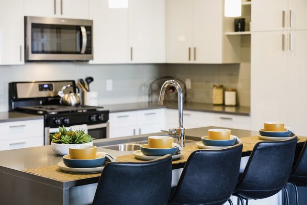 Modern kitchen with stainless steel appliances at Milagro Apartments