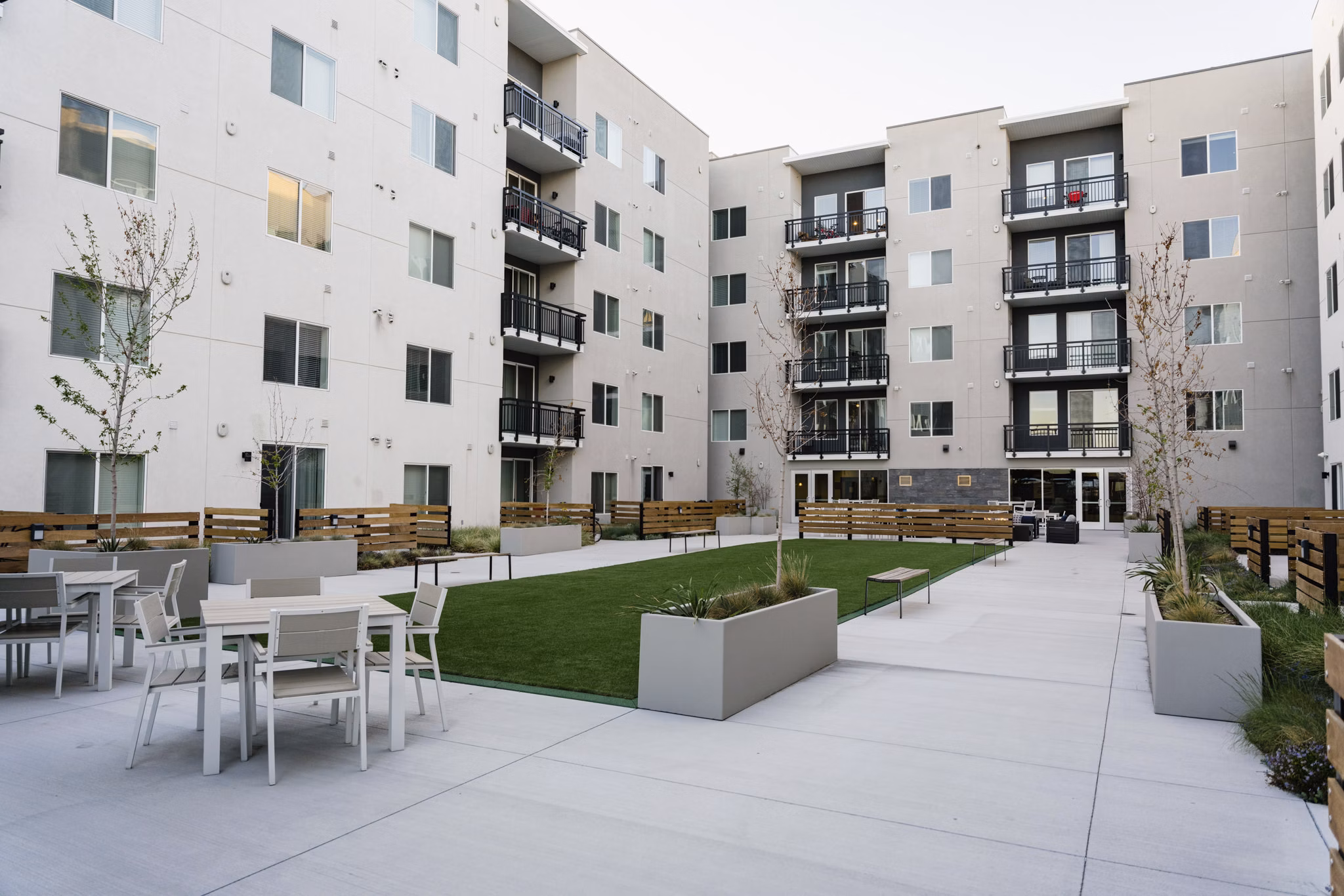 Spacious patio with modern furniture at Milagro Apartments, ideal for outdoor relaxation and entertainment
