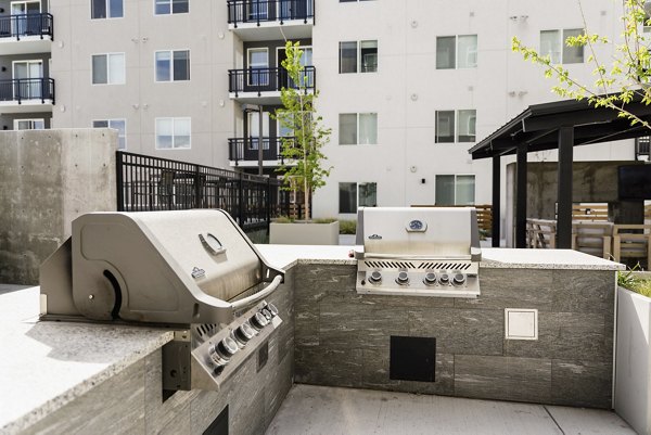 Elegant outdoor patio space at Milagro Apartments with comfortable seating and stylish design