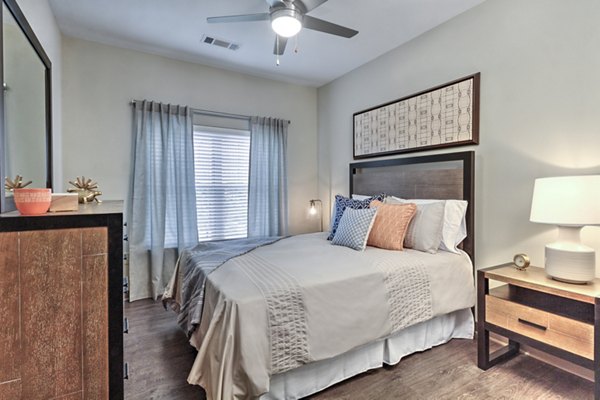 Luxurious bedroom with plush bedding at Cedar Flats Apartments