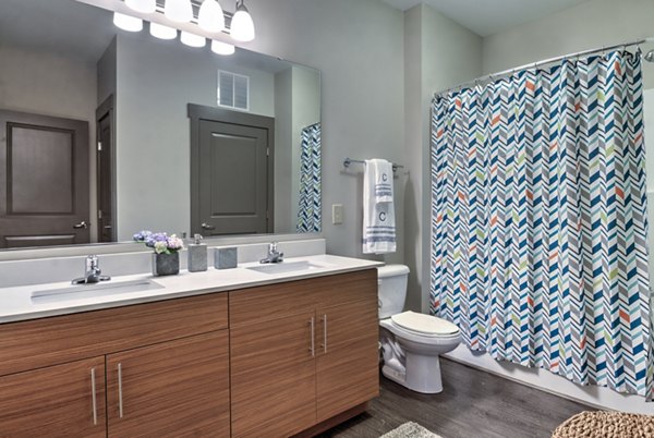 Modern bathroom with sleek fixtures and marble countertops in Cedar Flats Apartments