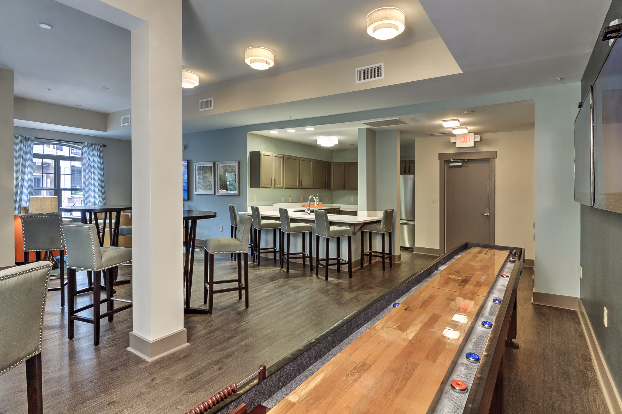 Modern clubhouse with plush seating and entertainment area at Cedar Flats Apartments