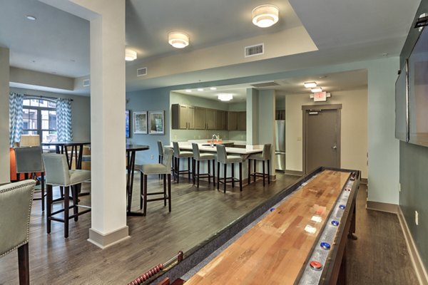 Modern clubhouse with plush seating and entertainment area at Cedar Flats Apartments