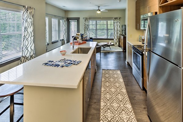 Contemporary kitchen with modern appliances at Cedar Flats Apartments