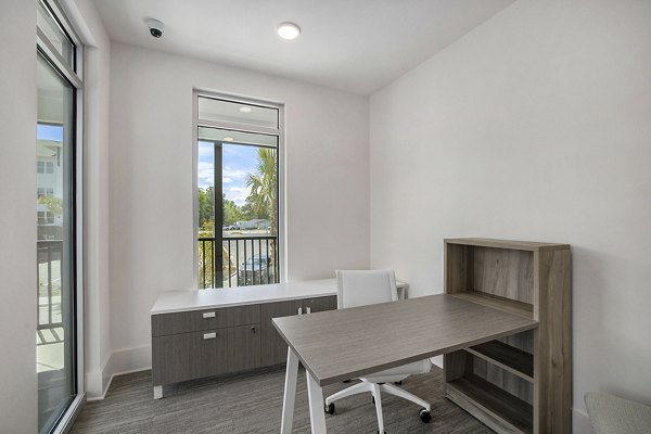 Clubhouse featuring modern design and spacious seating in Satori West Ashley Apartments