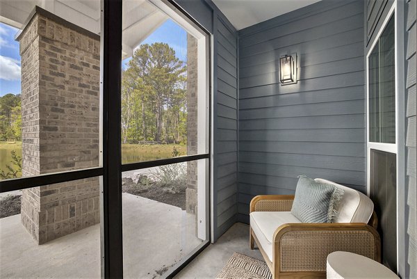 Modern clubhouse featuring a fireplace and seating at Satori West Ashley Apartments