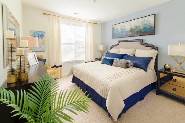 Cozy bedroom with modern decor at The Victor Stonebridge Apartments
