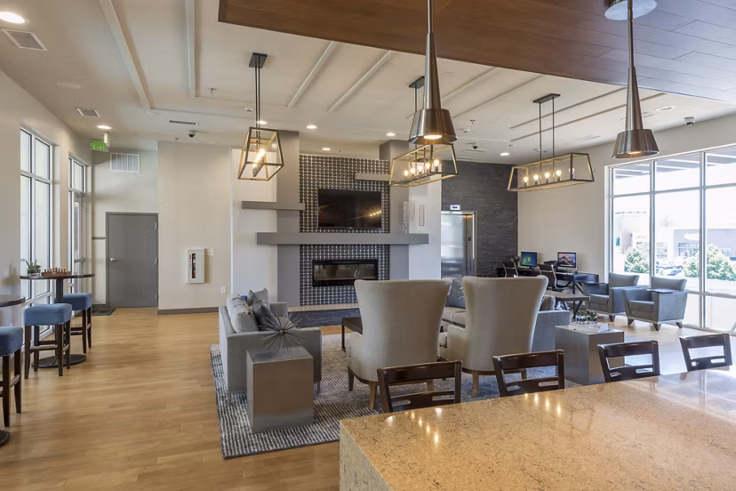 Modern clubhouse featuring upscale seating and entertainment options at The Victor Stonebridge Apartments