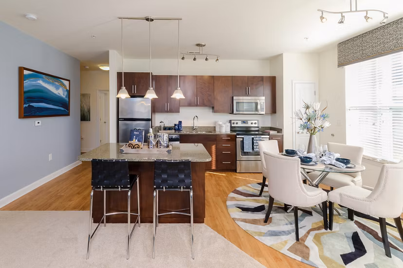 Dining area with modern lighting and sleek furnishings at The Victor Stonebridge Apartments