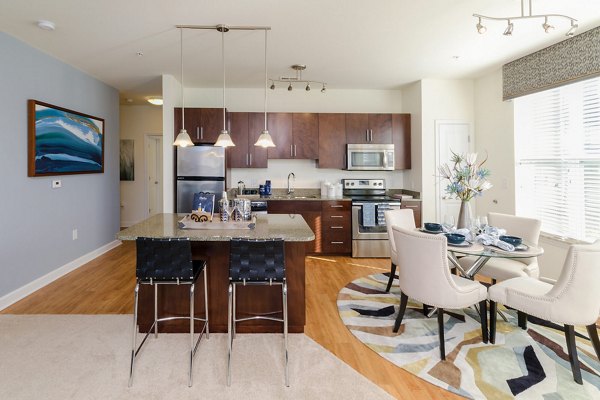 Dining area with modern lighting and sleek furnishings at The Victor Stonebridge Apartments