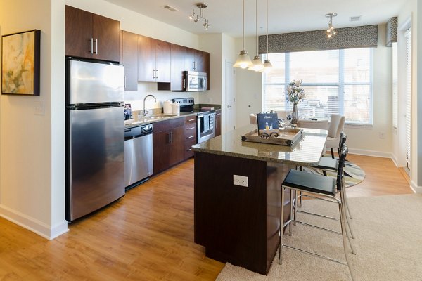 Modern kitchen with stainless steel appliances at The Victor Stonebridge Apartments