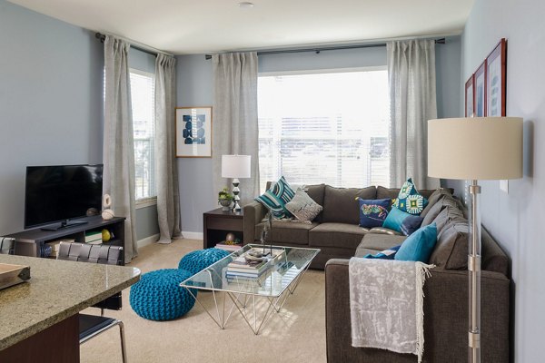 Spacious living room with modern decor in The Victor Stonebridge Apartments