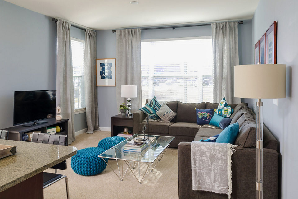 Spacious living room with modern decor in The Victor Stonebridge Apartments