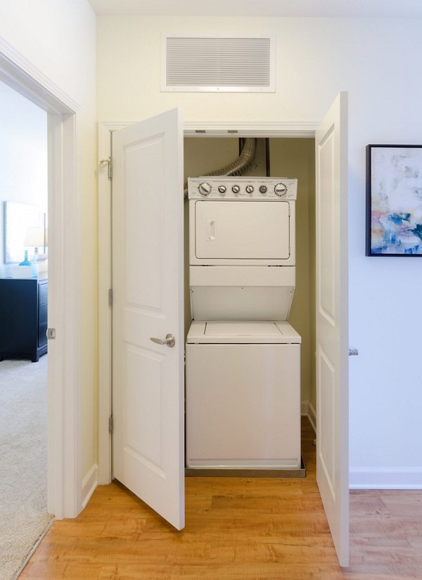 Laundry room with modern appliances at The Victor Stonebridge Apartments