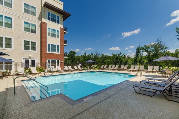 Resort-style pool with lounge seating at The Victor Stonebridge Apartments