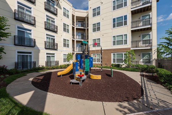 Modern playground featuring slides and swings at The Victor Stonebridge Apartments