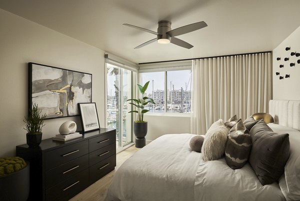 Cozy bedroom with ocean-view windows at Dolphin Marina Apartments, a luxury living option by  on the waterfront