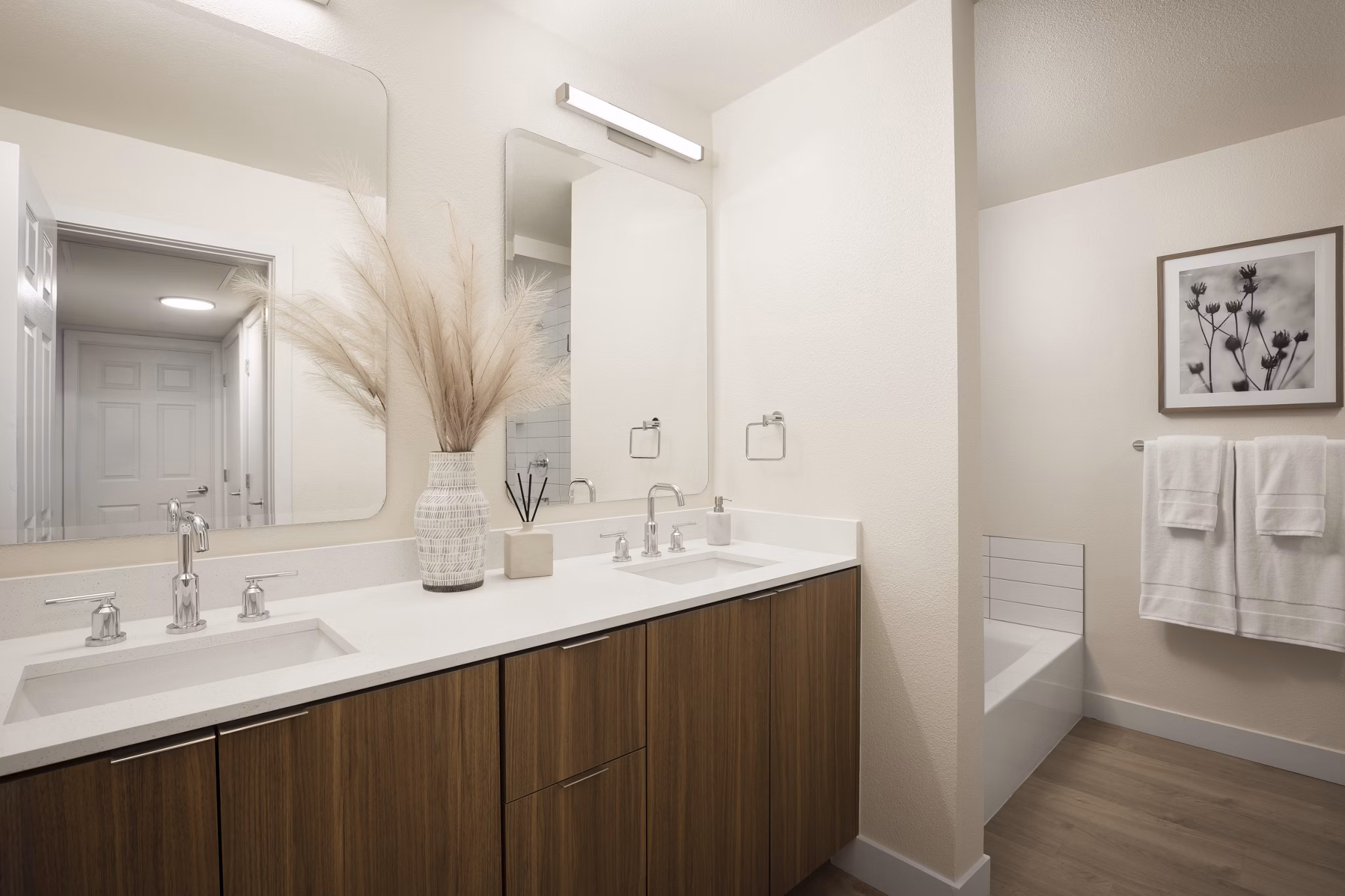 Bathroom with elegant fixtures and marble countertop at Dolphin Marina Apartments, a Greystar luxury apartment community