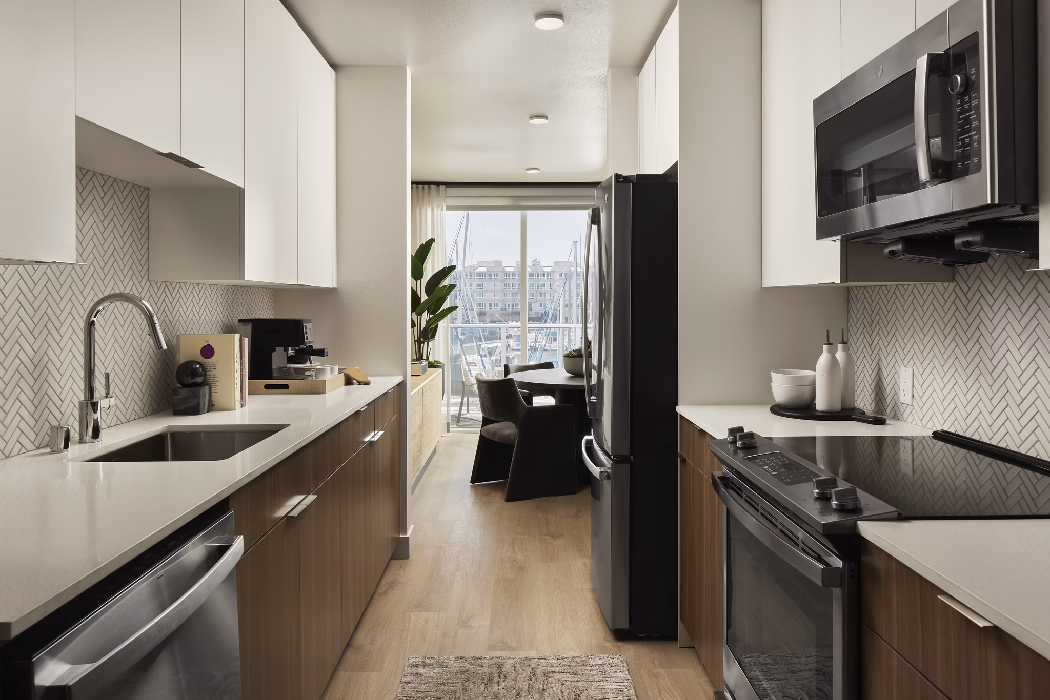 Modern kitchen featuring stainless steel appliances and granite countertops at Dolphin Marina Apartments