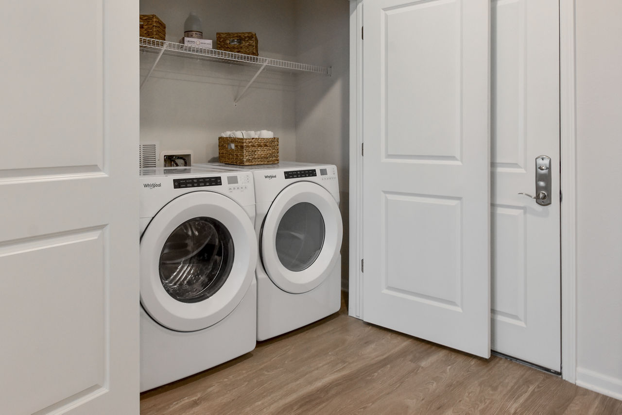 Laundry room at The View On Collins Apartments