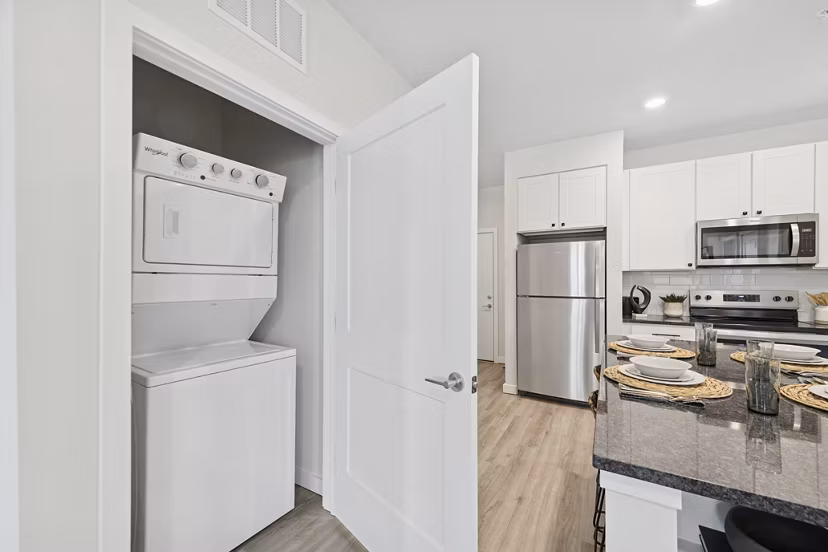 laundry room and kitchen at Ascend Brightleaf Apartments