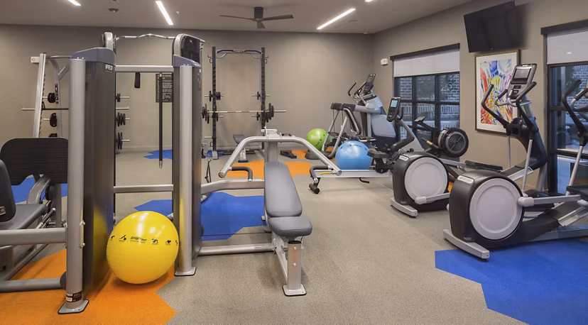 fitness center at Amelia at Farmers Market Apartments