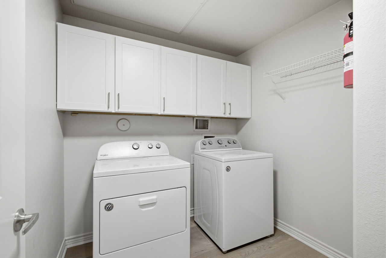 Laundry room at Riachi At One21