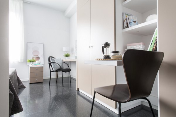 Cozy living room with modern decor at Roberto de Nobili Residence Hall, perfect for comfortable student living
