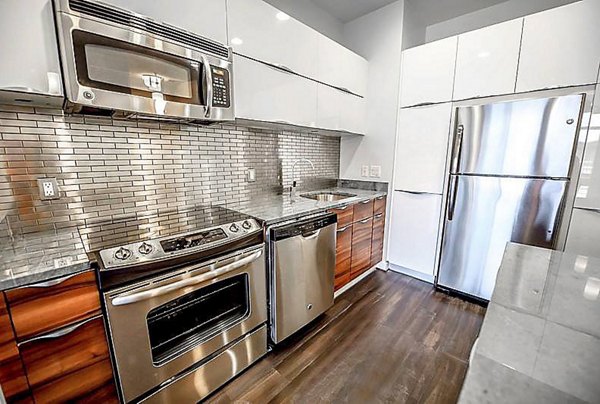 Elegant living room with cozy furnishings at PerSei at Pike & Rose Apartments